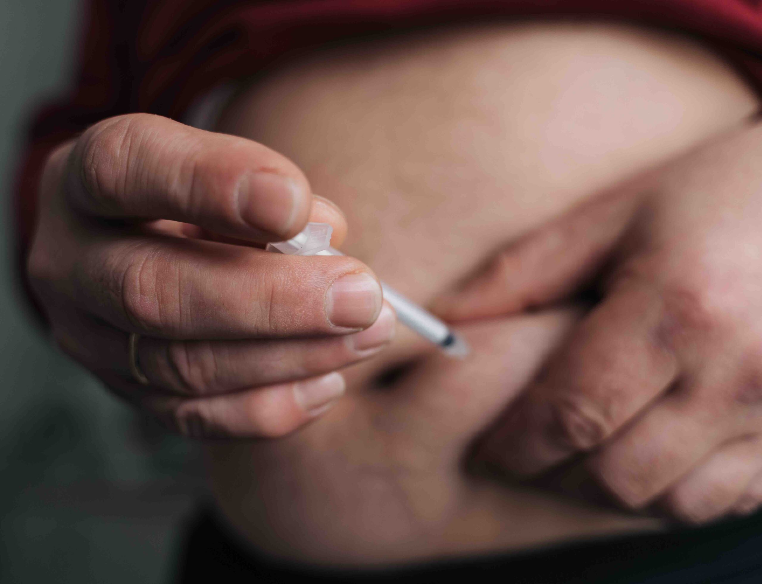 Mature man belly close-up doing insulin shot, diabetes illness Weight loss injections